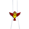 Climbing bird toy with spread red wings on two strings
