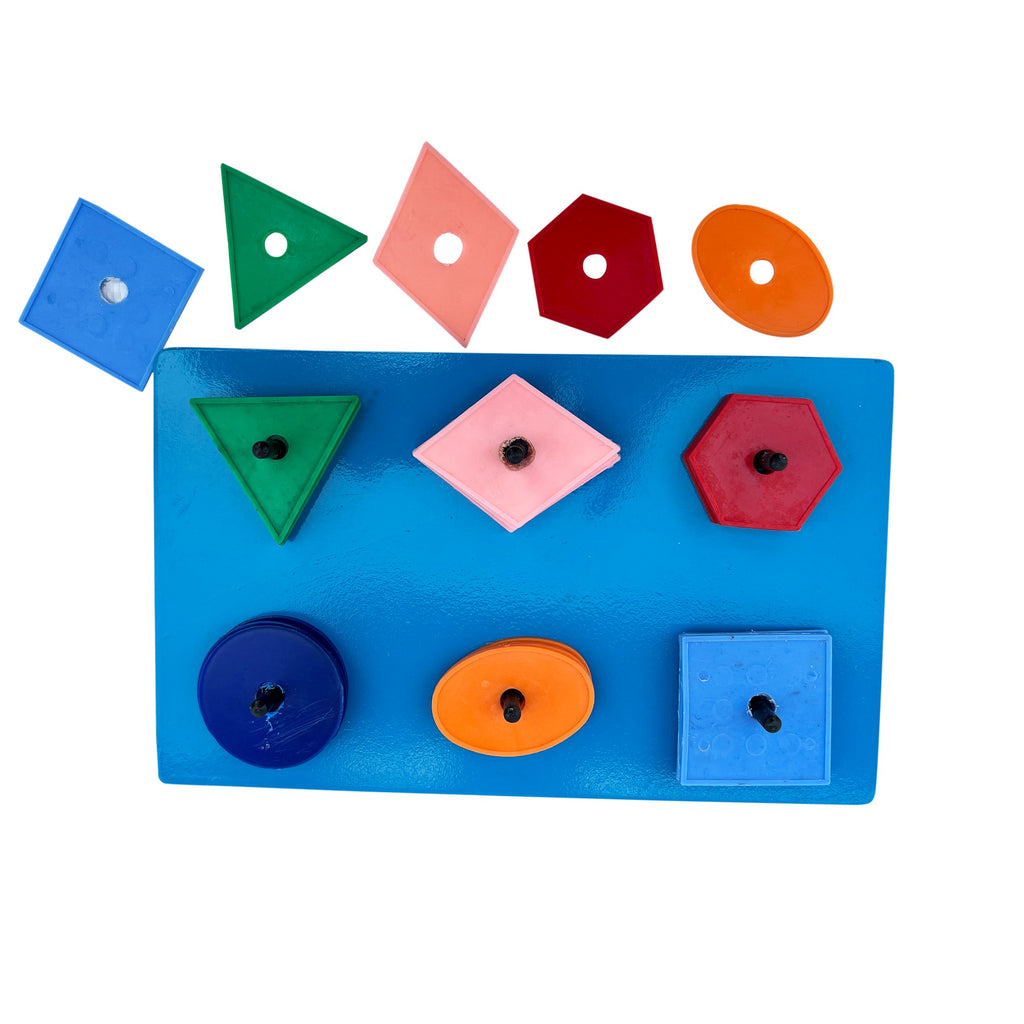 Sorting board with some shapes lifted off to show the outlines