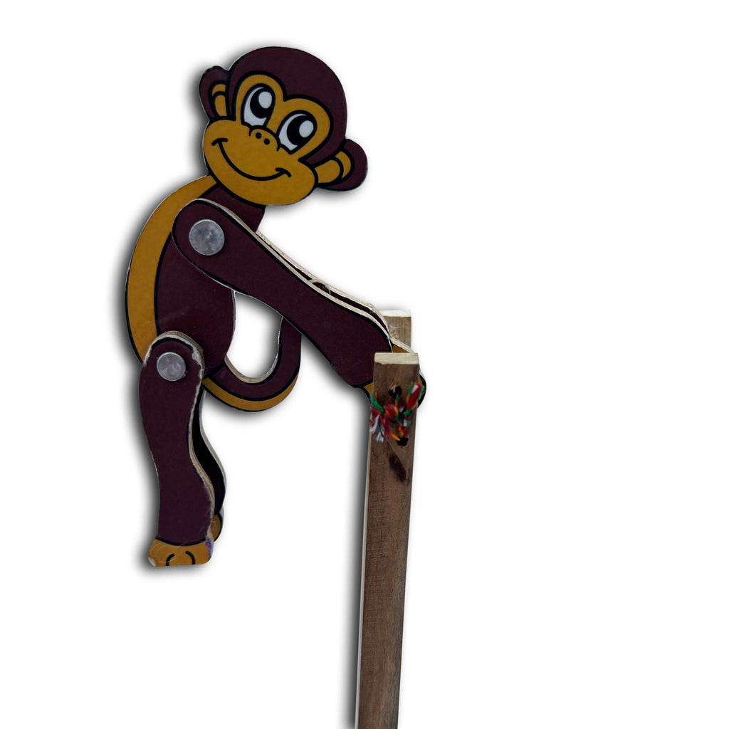 Jumping monkey gripping the stick top, side view