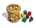 Round wooden cage with shape holes in the lid and coloured solid shapes