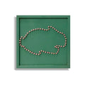 Beads mosaic board with beads forming a rabbit outline on a green board