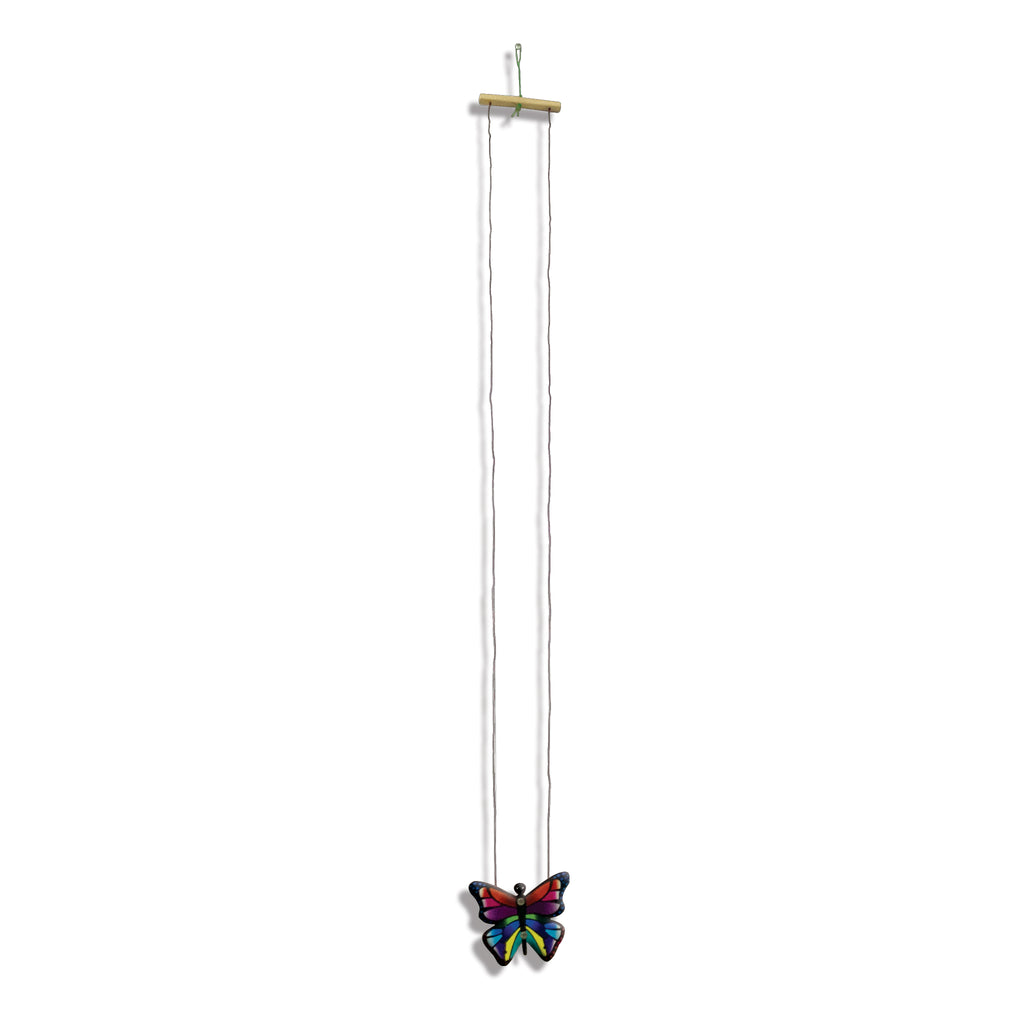 Climbing butterfly hanging from its wooden bar on two strings